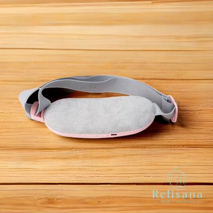 Relisana cordless heating pad in a soft fabric, designed for targeted pain relief and comfort, shown on a cozy blanket.